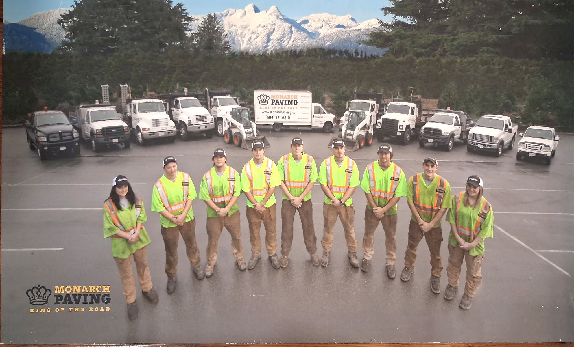 The Monarch Paving crew standing in front of company vehicles and roadwork equipment.